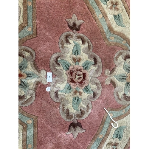 46 - Three rugs, two Oushak style pink ground - approx. 130cm x 62cm and one Chinese pink floral - approx... 