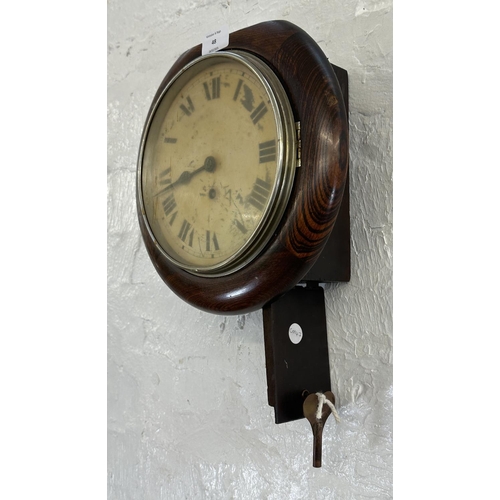 48 - A 19th century oak cased wall clock with pendulum and key - approx. 28cm high x 29cm wide