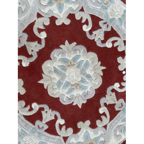 52 - A Flair Rugs Lotus Premium Aubusson red ground floral pattern rug - approx. 120cm diameter