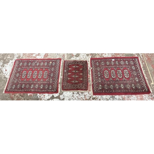 54 - Three mid 20th century Bokhara rugs - largest approx. 97cm x 65cm