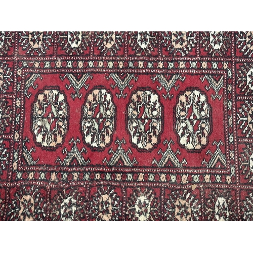 54 - Three mid 20th century Bokhara rugs - largest approx. 97cm x 65cm