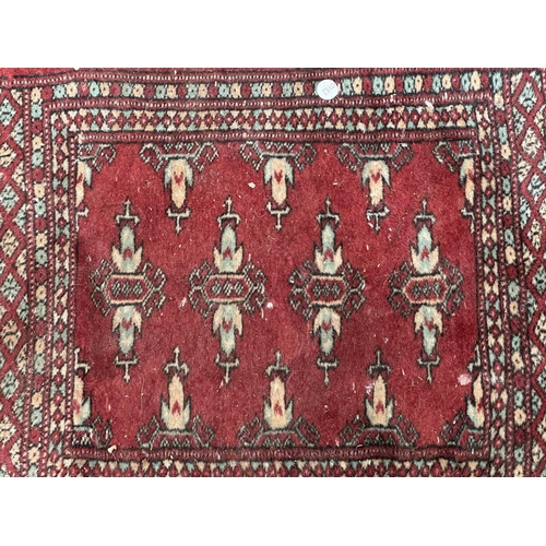 54 - Three mid 20th century Bokhara rugs - largest approx. 97cm x 65cm