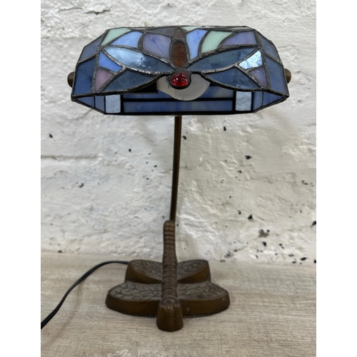 56 - A Tiffany style stained glass and bronzed dragonfly desk lamp - approx. 33cm high