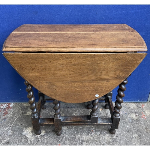 70 - Two early 20th century oak drop leaf gate leg barley twist occasional tables - largest approx. 72cm ... 