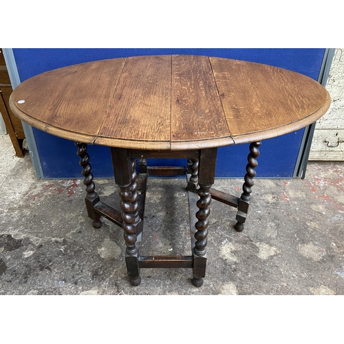 70 - Two early 20th century oak drop leaf gate leg barley twist occasional tables - largest approx. 72cm ... 