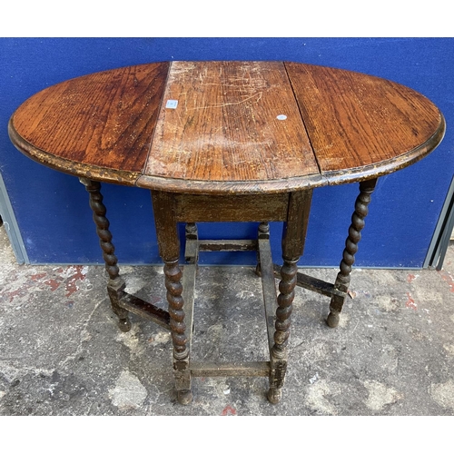 70 - Two early 20th century oak drop leaf gate leg barley twist occasional tables - largest approx. 72cm ... 