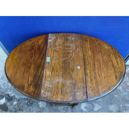 70 - Two early 20th century oak drop leaf gate leg barley twist occasional tables - largest approx. 72cm ... 