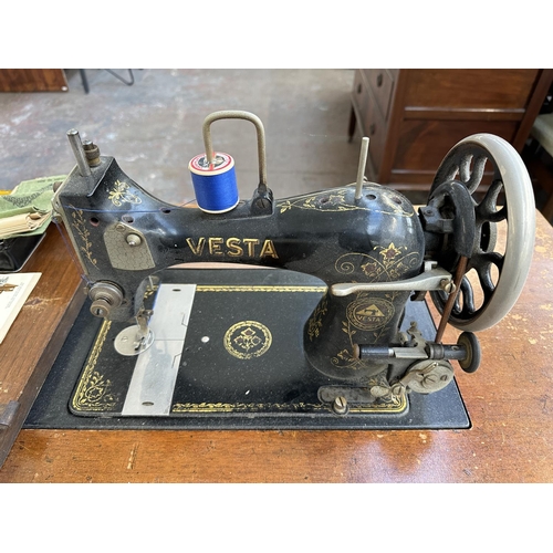 739 - An antique German Vesta treadle sewing machine with drawers and tin containing accessories and instr... 