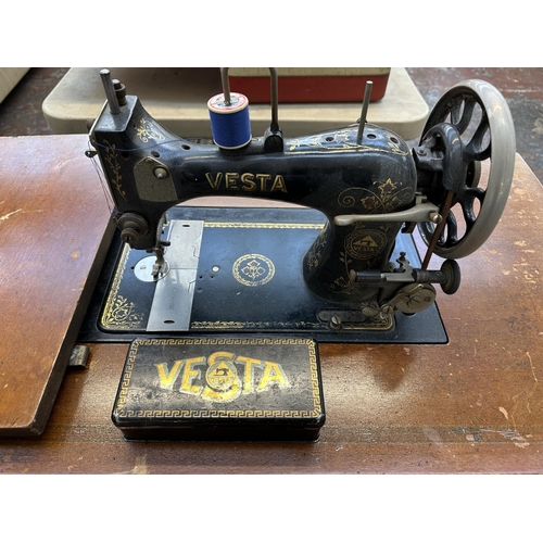 739 - An antique German Vesta treadle sewing machine with drawers and tin containing accessories and instr... 