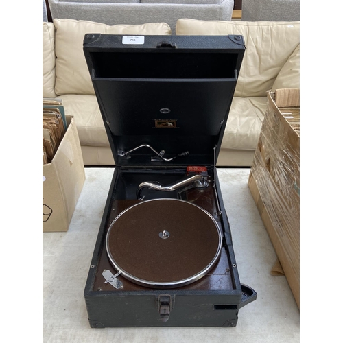 744 - A His Master's Voice portable gramophone with winding handle, needles and two boxes of shellac recor... 