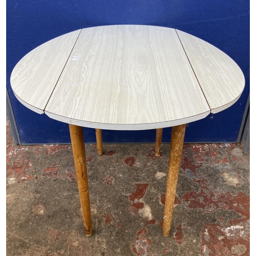 80 - A mid 20th century white melamine and beech drop leaf kitchen table - approx. 75cm high x 86cm wide ... 