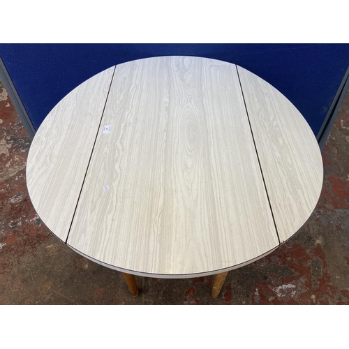 80 - A mid 20th century white melamine and beech drop leaf kitchen table - approx. 75cm high x 86cm wide ... 