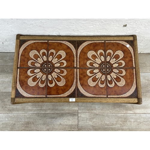 99 - A mid 20th century teak ceramic tile top coffee table - approx. 40cm high x 48cm wide x 86cm long