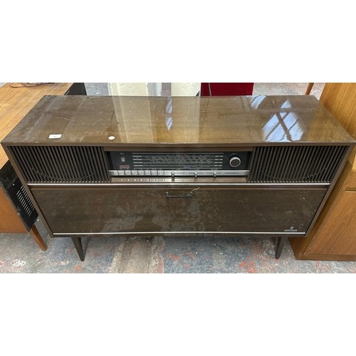 755 - A mid 1970s Grundig Mandello 8 solid state radiogram comprising four-speed turntable and four-band r... 