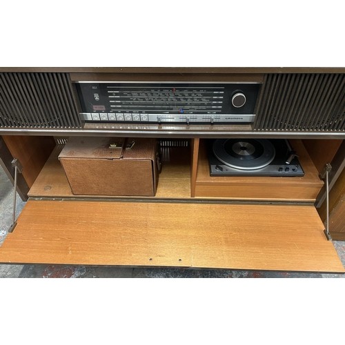 755 - A mid 1970s Grundig Mandello 8 solid state radiogram comprising four-speed turntable and four-band r... 