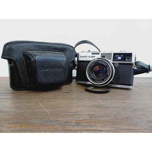 955 - A cased Olympus 35 SP spot and center-weighted metering 35mm rangefinder camera fitted with G. Zuiko... 