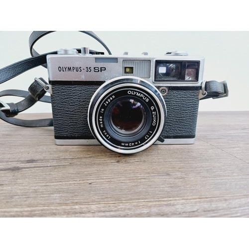 955 - A cased Olympus 35 SP spot and center-weighted metering 35mm rangefinder camera fitted with G. Zuiko... 