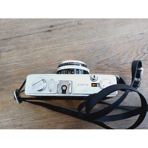 955 - A cased Olympus 35 SP spot and center-weighted metering 35mm rangefinder camera fitted with G. Zuiko... 