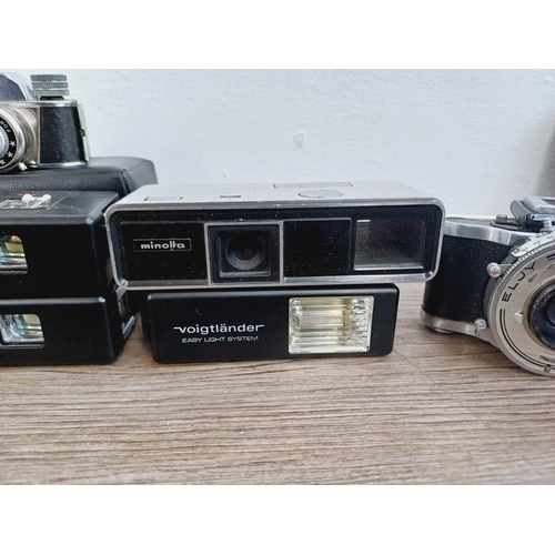 958 - Eight miniature cameras to include Minolta-16, two cased Voigtländer Vitoret 110 EL, Ensign Midget, ... 