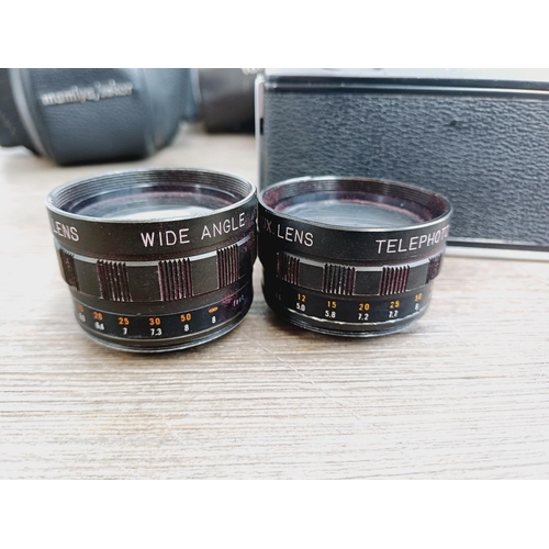 959 - Two cased vintage Japanese 35mm cameras with their cased auxiliary lenses, one Mamiya/Sekor 528TL le... 