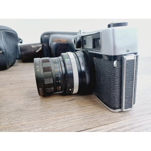 959 - Two cased vintage Japanese 35mm cameras with their cased auxiliary lenses, one Mamiya/Sekor 528TL le... 