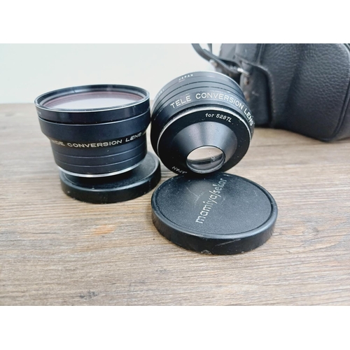 959 - Two cased vintage Japanese 35mm cameras with their cased auxiliary lenses, one Mamiya/Sekor 528TL le... 