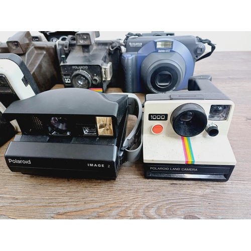 948 - Twelve instant cameras to include Fujifilm Instax 100, Polaroid The Button, Polaroid P, Kodak EK2, P... 