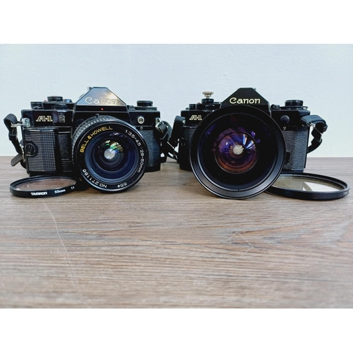 949 - Two Canon A-1 35mm SLR cameras, one fitted with Makinon MC 1:3.5-4.5 28-80mm auto zoom lens and one ... 