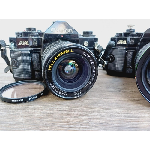 949 - Two Canon A-1 35mm SLR cameras, one fitted with Makinon MC 1:3.5-4.5 28-80mm auto zoom lens and one ... 