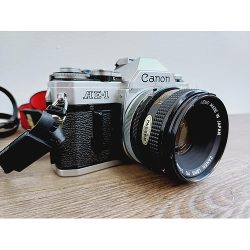 951 - Two Canon AE-1 35mm SLR cameras, one fitted with Optomax 1:2.8 135mm lens and one fitted with FD S.C... 