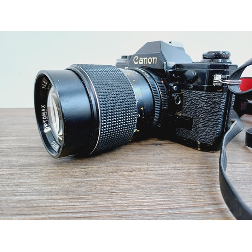 951 - Two Canon AE-1 35mm SLR cameras, one fitted with Optomax 1:2.8 135mm lens and one fitted with FD S.C... 