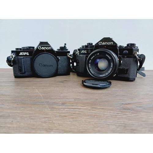 953 - Two Canon 35mm SLR cameras, one A-1 fitted with FD 1:1.8 50mm lens and one AV-1 body