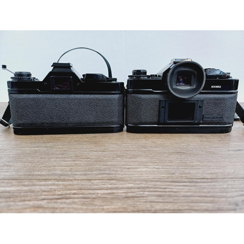 953 - Two Canon 35mm SLR cameras, one A-1 fitted with FD 1:1.8 50mm lens and one AV-1 body