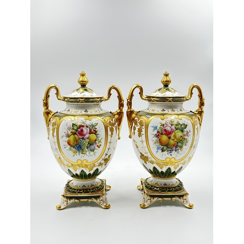 537 - A pair of Royal Crown Derby hand painted twin handled lidded urn vases, signed C. Gresley - approx. ... 