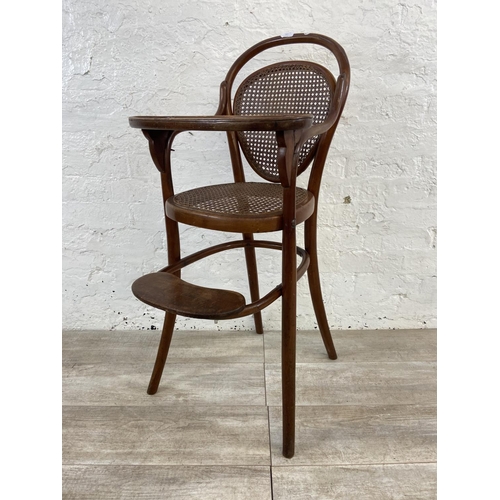 12 - An early 20th century Thonet style bentwood and cane child's high chair - approx. 100cm high