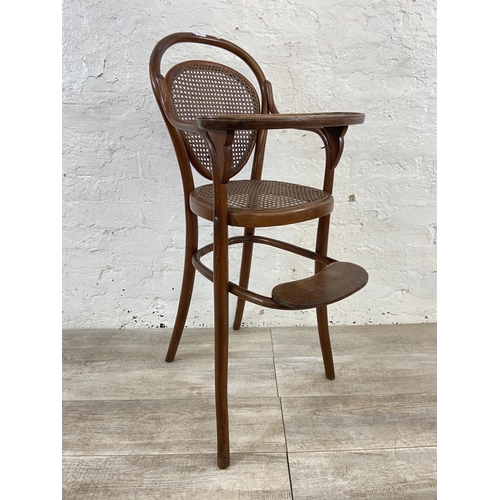 12 - An early 20th century Thonet style bentwood and cane child's high chair - approx. 100cm high