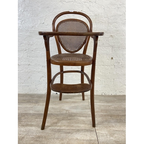 12 - An early 20th century Thonet style bentwood and cane child's high chair - approx. 100cm high