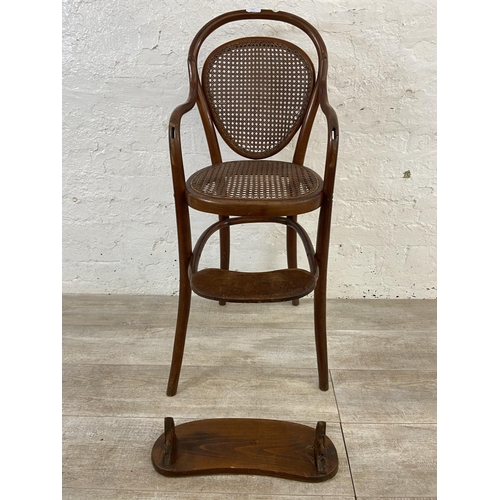 12 - An early 20th century Thonet style bentwood and cane child's high chair - approx. 100cm high