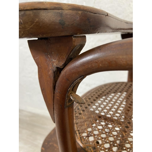 12 - An early 20th century Thonet style bentwood and cane child's high chair - approx. 100cm high