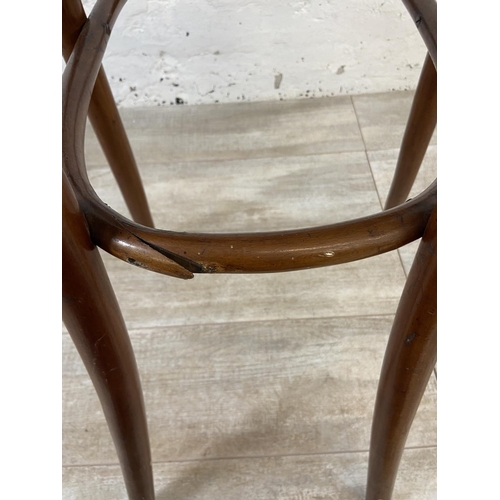 12 - An early 20th century Thonet style bentwood and cane child's high chair - approx. 100cm high