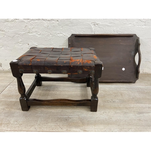 85 - Two items, one early 20th century beech twin handled tray and one beech and brown leather footstool