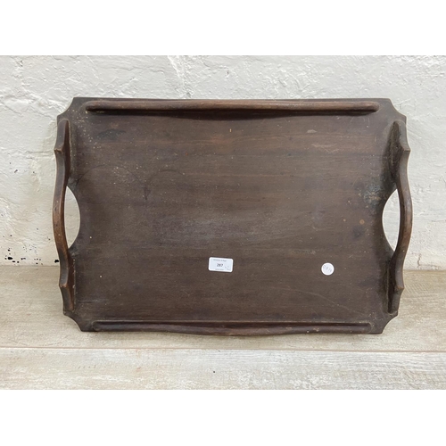 85 - Two items, one early 20th century beech twin handled tray and one beech and brown leather footstool