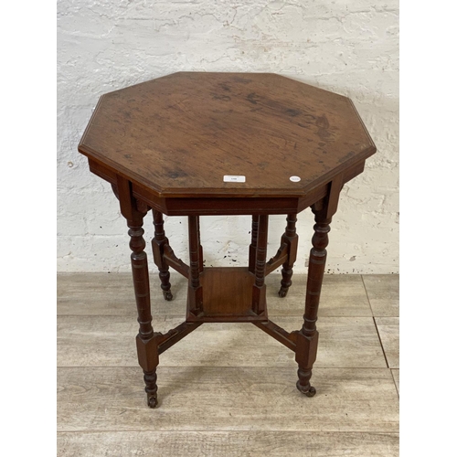 86 - A Victorian walnut octagonal two tier side table - approx. 70cm high x 59cm wide x 59cm deep