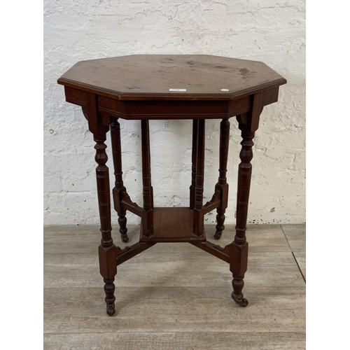 86 - A Victorian walnut octagonal two tier side table - approx. 70cm high x 59cm wide x 59cm deep