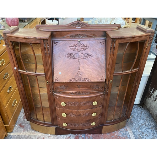 109 - An early/mid 20th century stained and carved oak side by side bureau bookcase - approx. 122cm high x... 