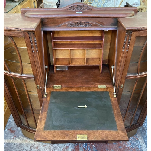 109 - An early/mid 20th century stained and carved oak side by side bureau bookcase - approx. 122cm high x... 