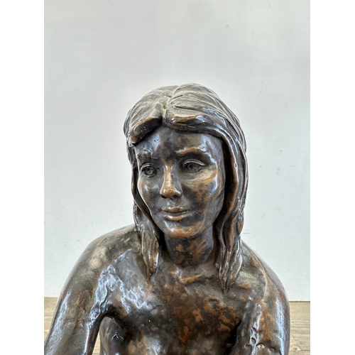 773 - A hand finished cold cast bronzed resin female seated nude figurine - approx. 45cm high