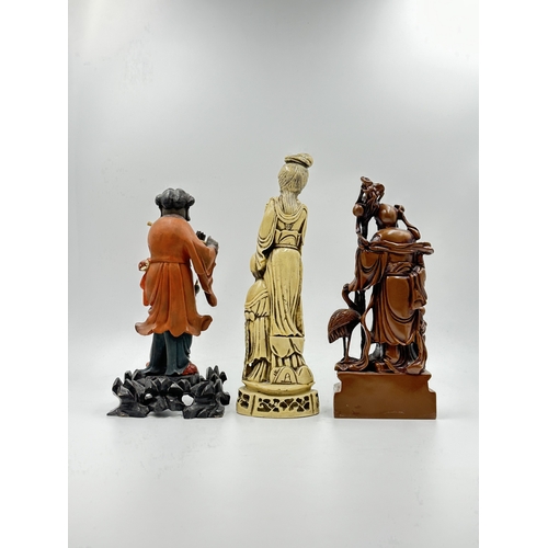 786 - Three Oriental figurines, two resin and one carved wooden and lacquered - largest approx. 28cm high