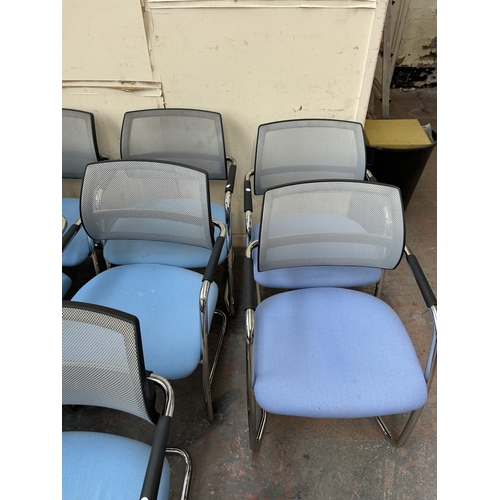 320 - Eight modern tubular metal desk chairs with blue fabric seats and grey mesh back rest