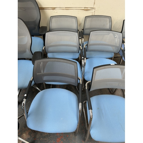 320 - Eight modern tubular metal desk chairs with blue fabric seats and grey mesh back rest